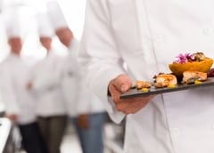 chef holding plate of food