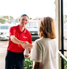Handyman shaking hands with customer 