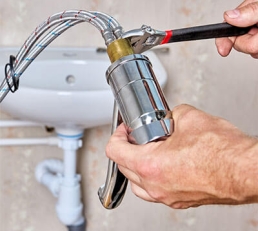 Plumber using wrench on fitting