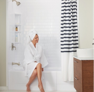 woman sitting on side of bathtub