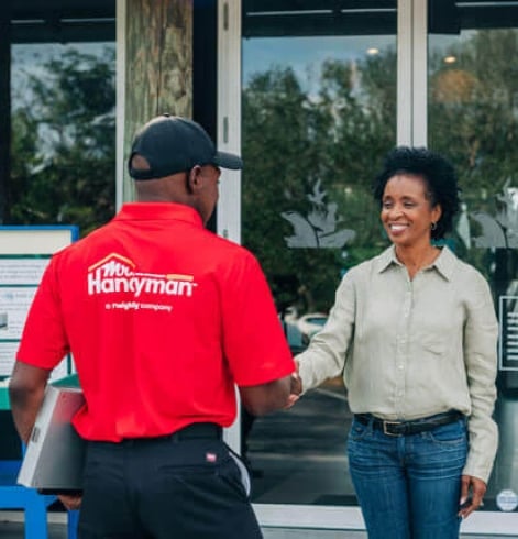 Mr. Handyman technician shaking hands with customer