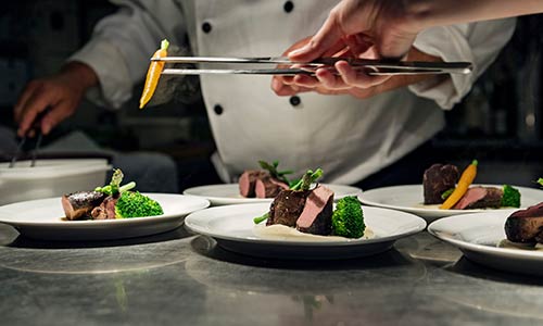 Chefs plating carrots