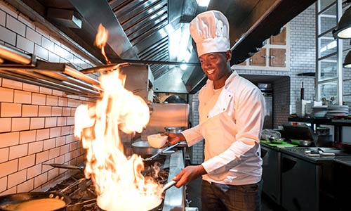 Chef cooking with fiery pan