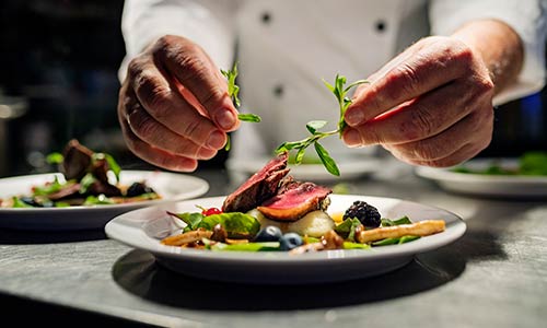 Chef garnishing a plate