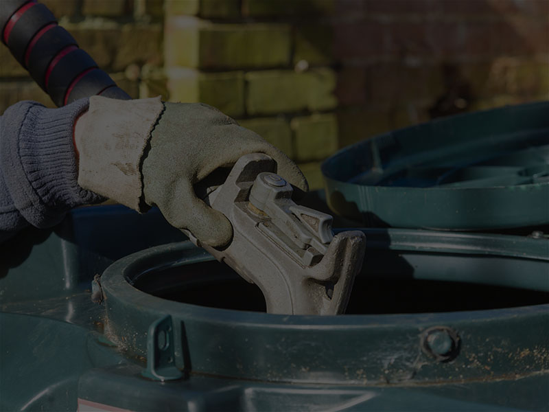 hand holding nozzle filling up kerosene or oil storage container