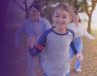 Family smiling and running outside