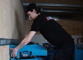 Person loading equipment into truck