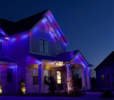 Two story home with multicolored led lights