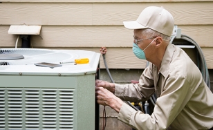Technician repairing an A/C unit