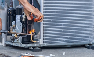 Technician repairing an A/C unit