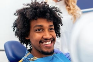 smiling man in dental chair