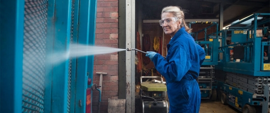 Person using a power washer