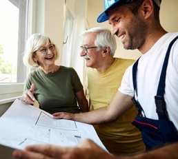 Builder going over plans with homeowners