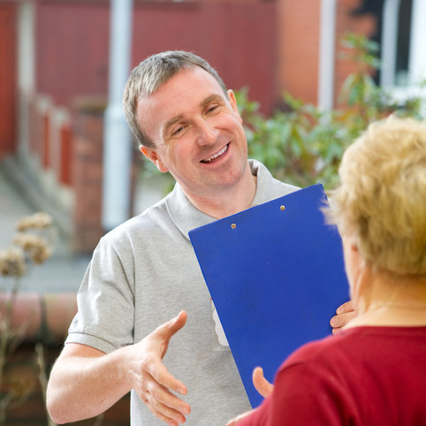Photo of a man greet an elderly woman