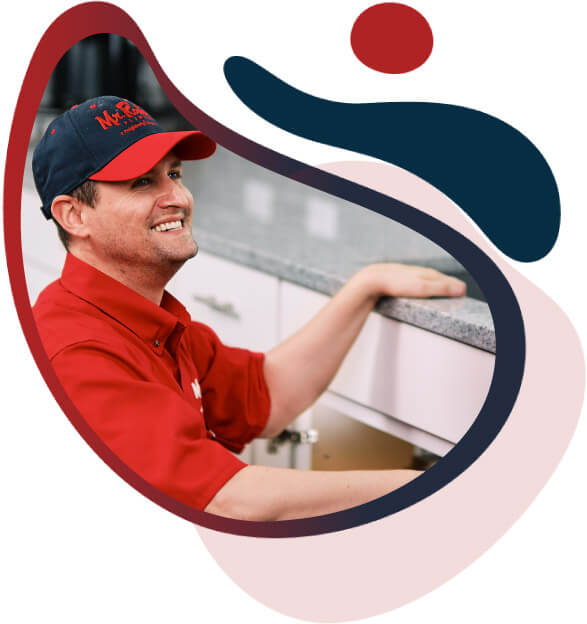 Mr. Rooter plumber working in a kitchen