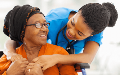 Health professional helping elderly woman