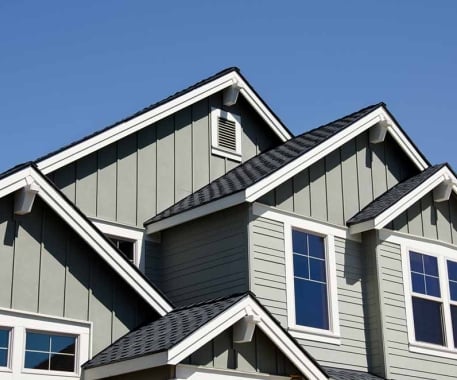 Close up of a daytime exterior showing the details of the different level roofs