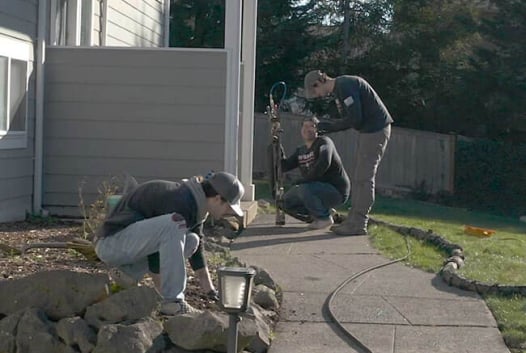 Three people working on concrete