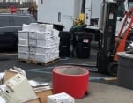 Boxes of paper to shred being loaded into truck