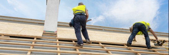 two men replacing a roof image