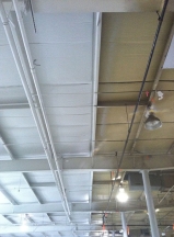 Before and after painting of industrial building ceiling