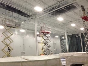 Painting interior of industrial building with lifts