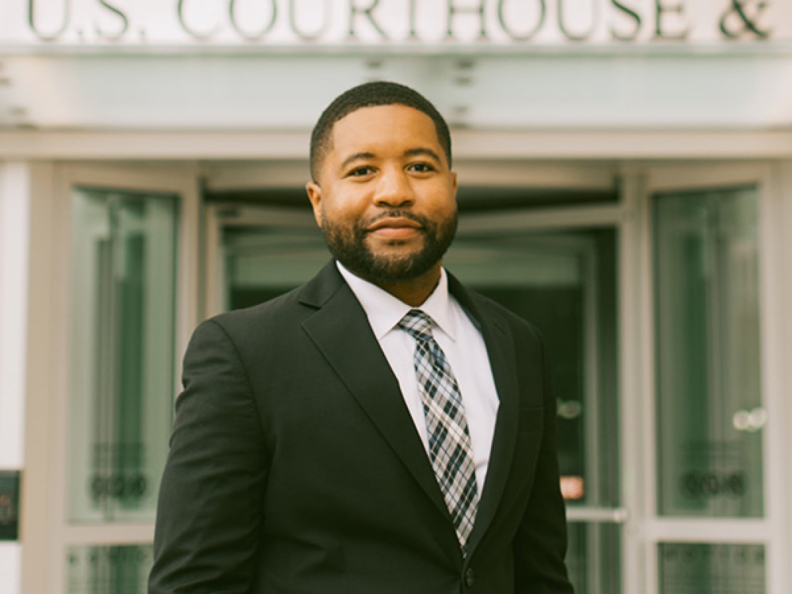Syracuse student in front of a U.S. Courthouse