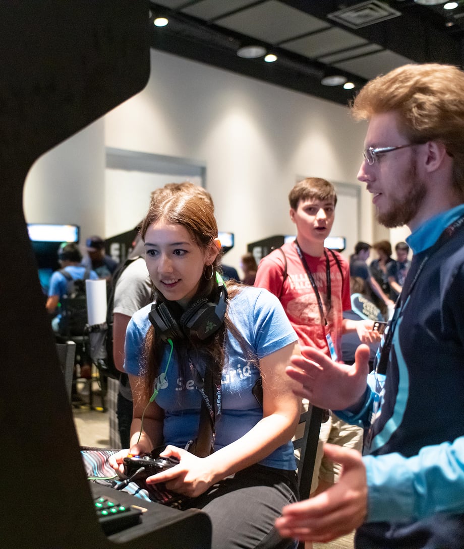 DigiPen Student playing a game at an arcade cabinet