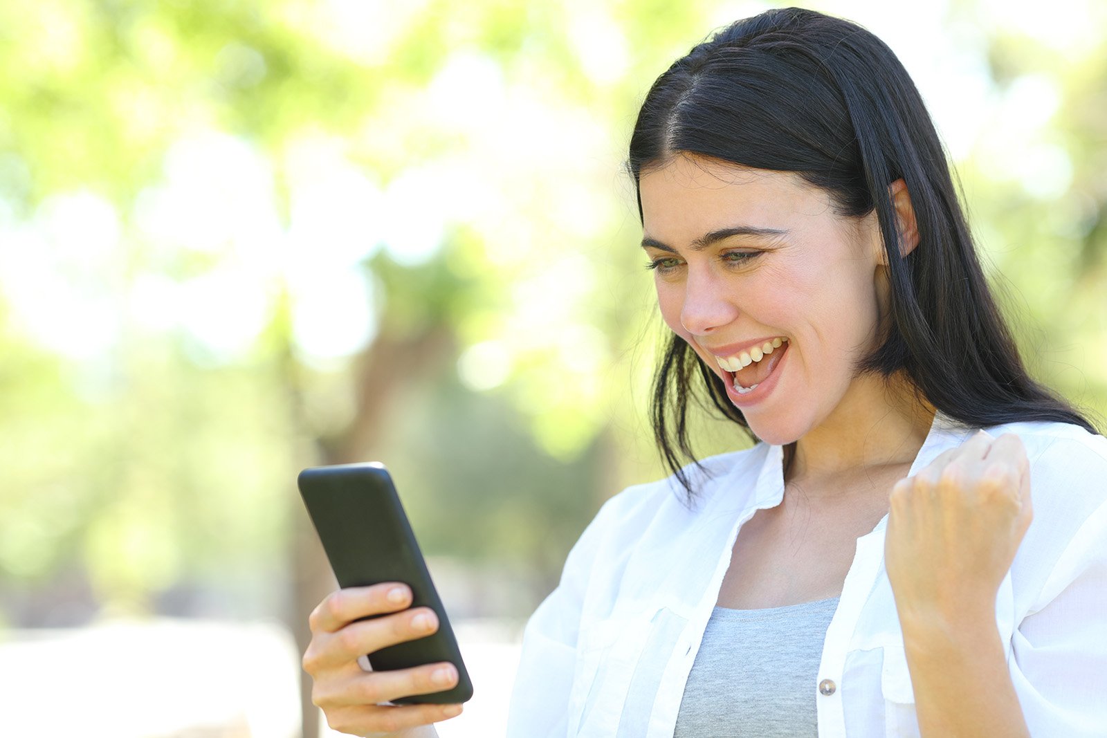 woman smiling at cell phone