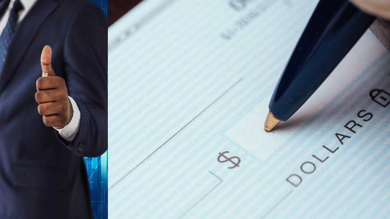 man giving thumbs-up and pen writing on check