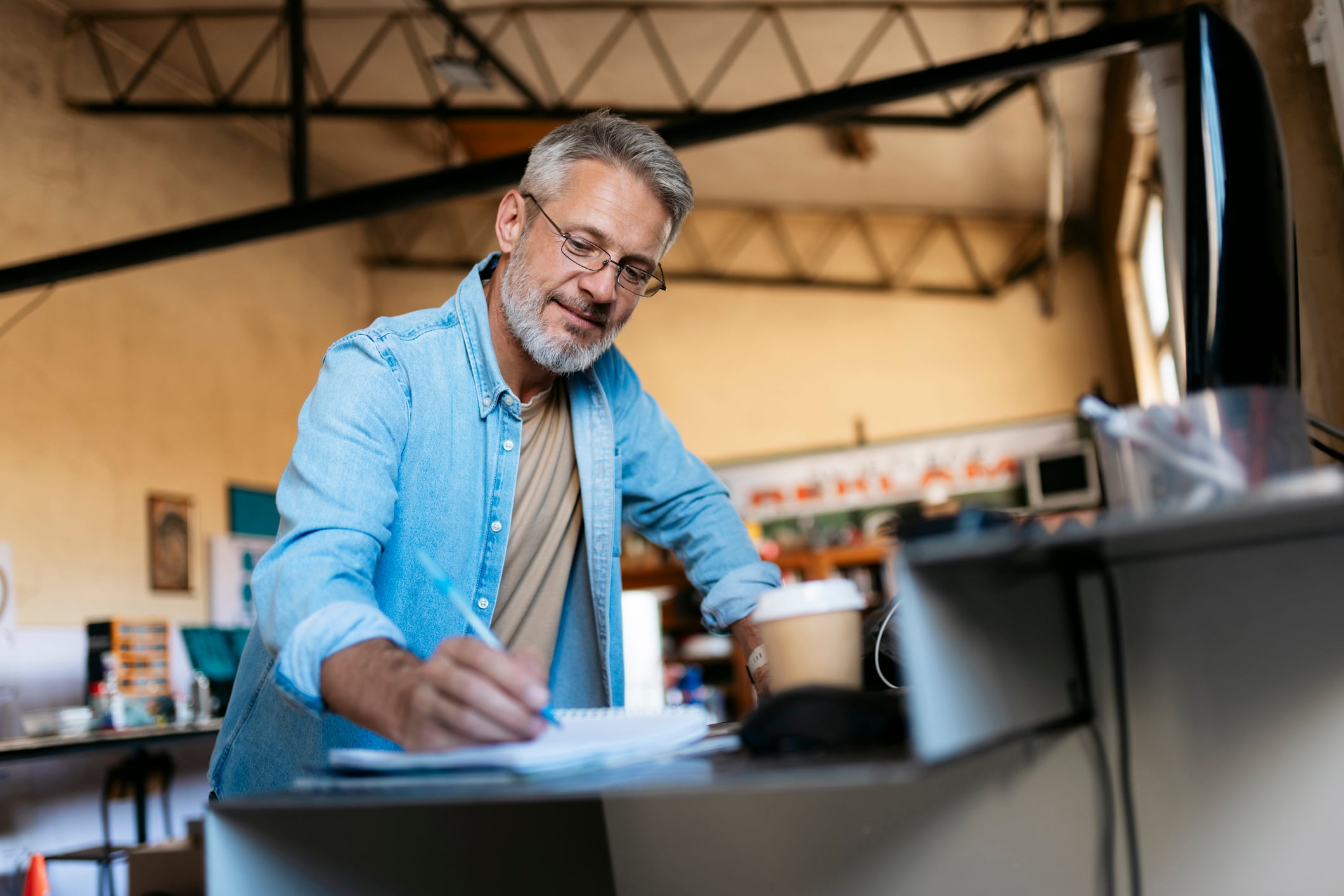 A man who owns a small business on his computer