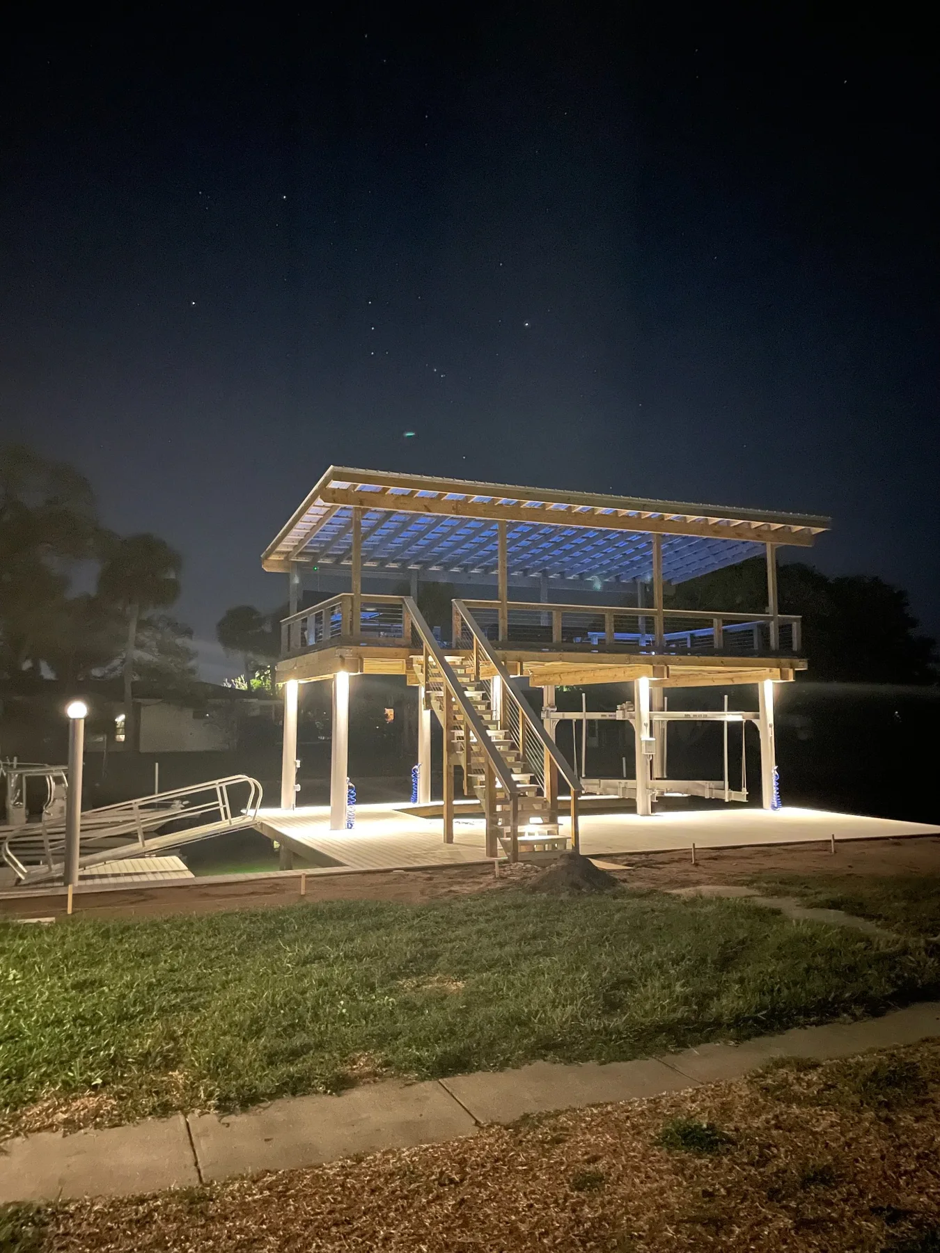 Two-level dock at night during roof and lighting completion