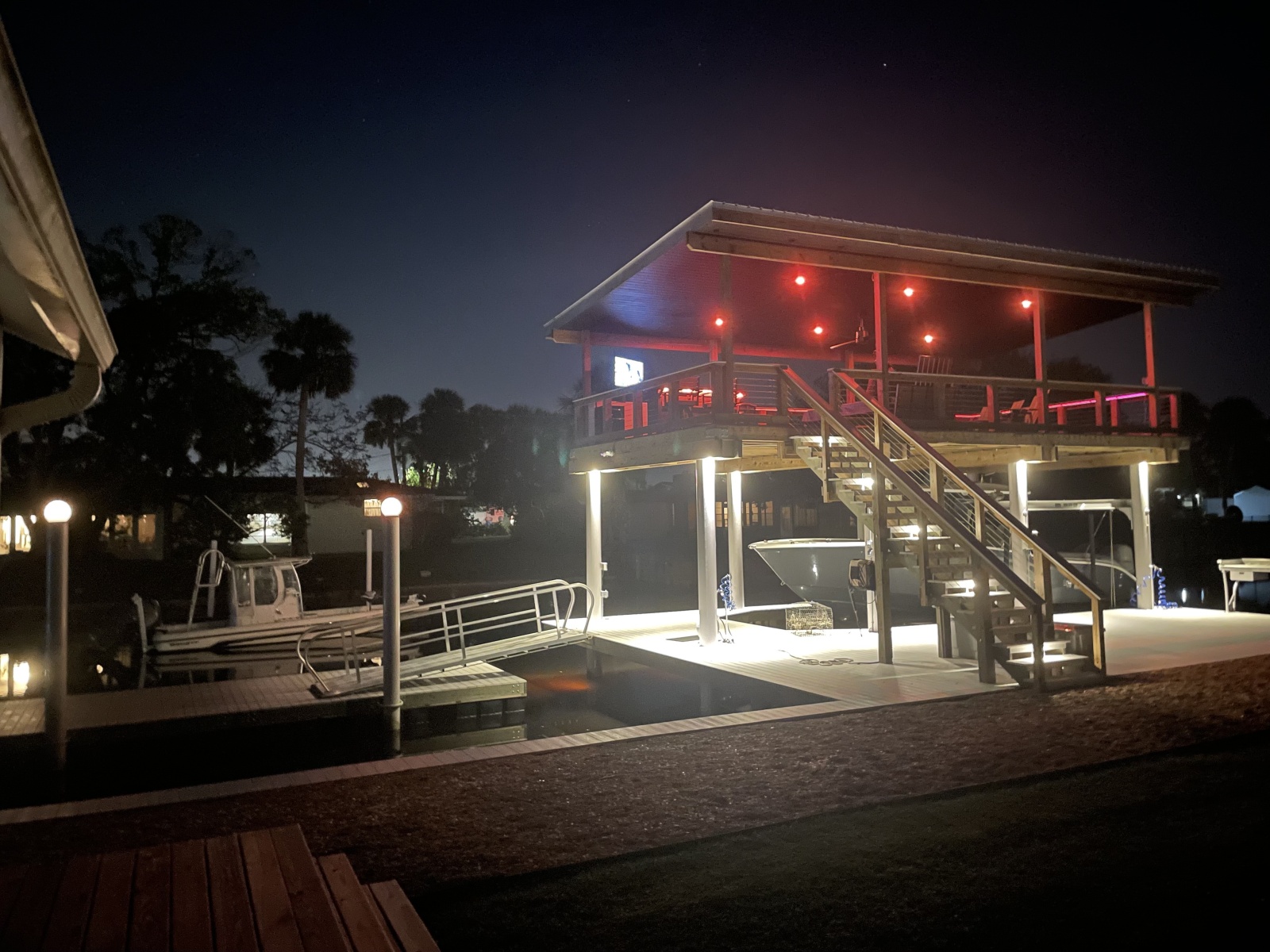 Complete custom dock with warm upper-deck lighting