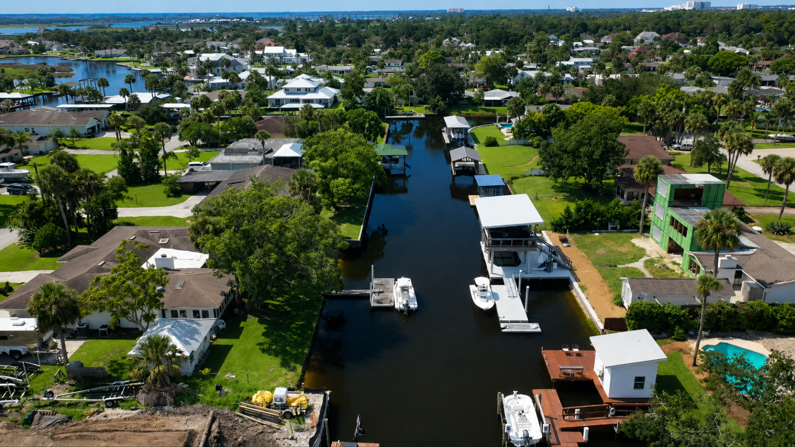 Wide aerial view of the featured custom dock and surrounding Northeast Florida canal neighborhood