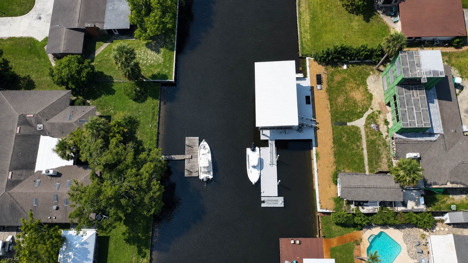 Top-down aerial view of the custom dock footprint, boat lift and canal access
