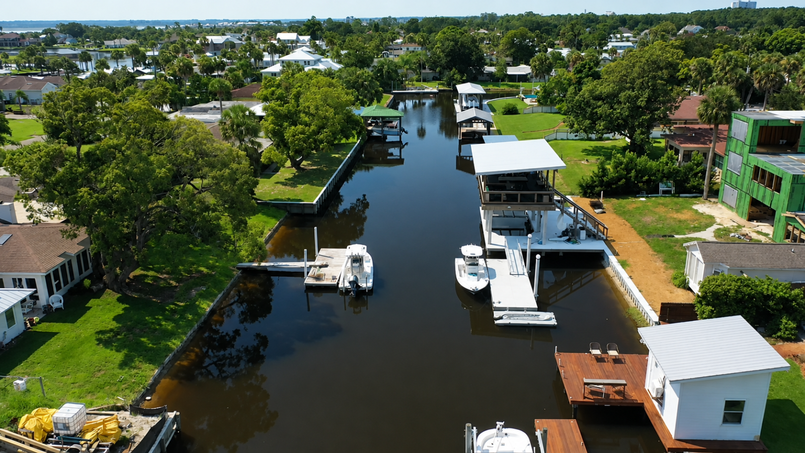 Aerial canal approach showing Hugh Holborn's two-level custom dock in its waterfront setting
