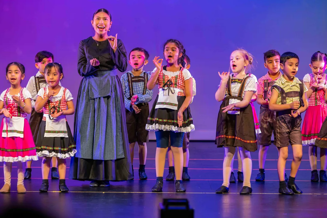 PerformX Academy students singing together on stage