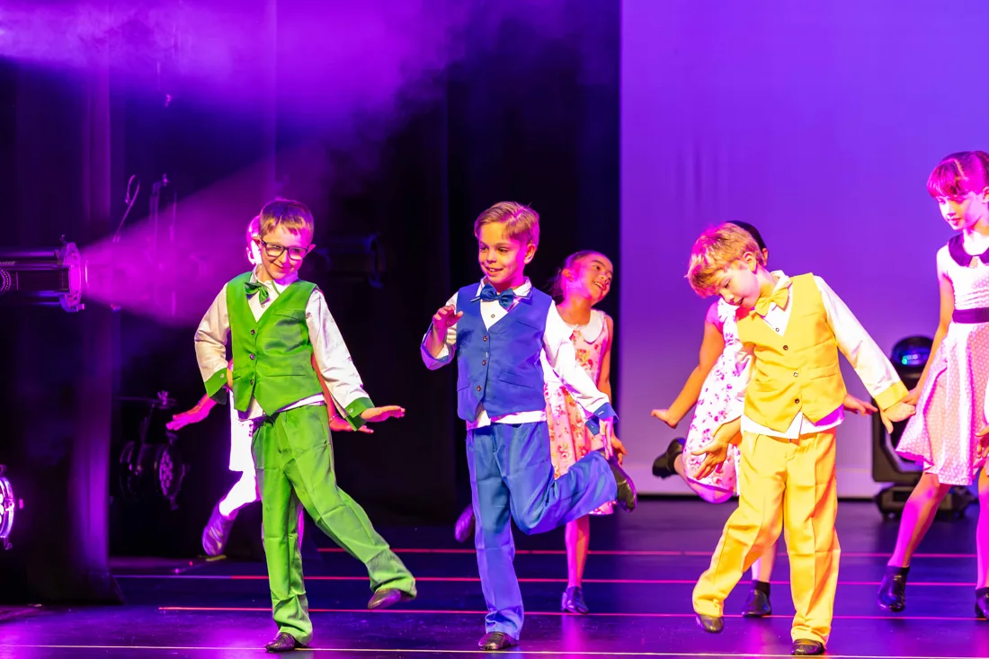 PerformX Academy students dancing in colourful stage costumes