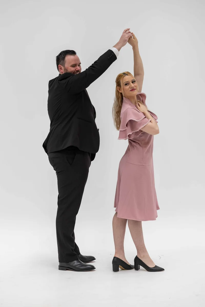 Warbucks twirling Grace in a dance pose