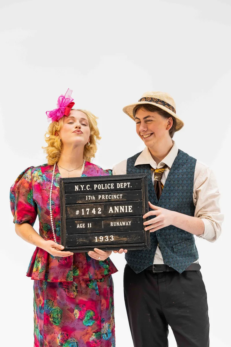 Rooster and Lily posing with a police board