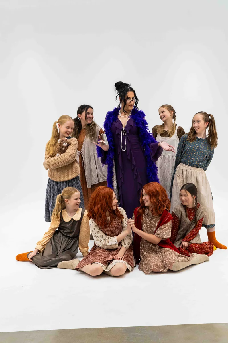 Both Annies and all six orphans laughing together with Miss Hannigan