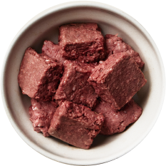 dog bowl of raw meat patties cut up