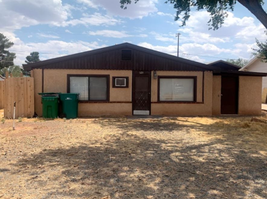 Single-story home with worn exterior and minimal curb appeal, ideal for a quick home sale.