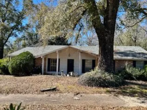 Single-story home with visible exterior wear, ideal for a fixer-upper purchase.