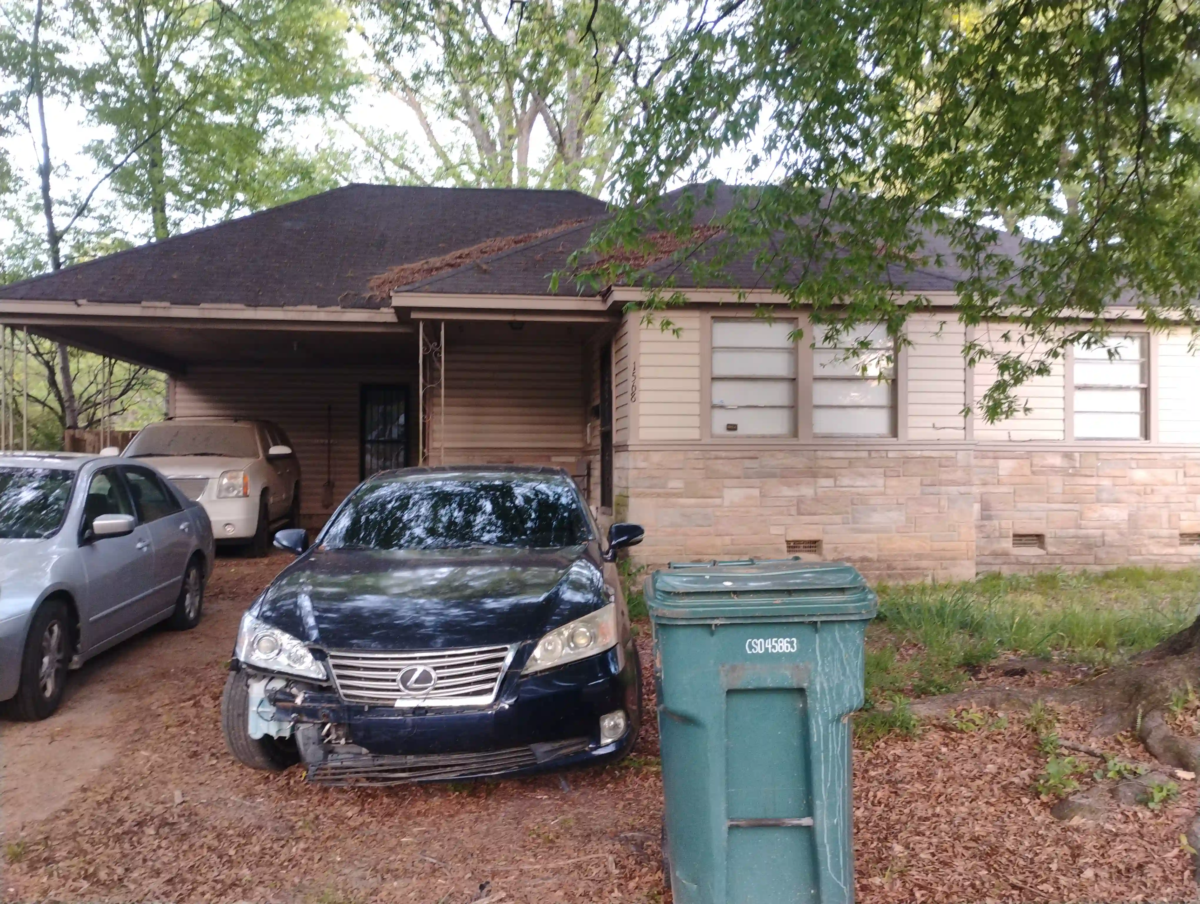 Older single-story home with worn exterior, suitable for renovation or cash purchase.