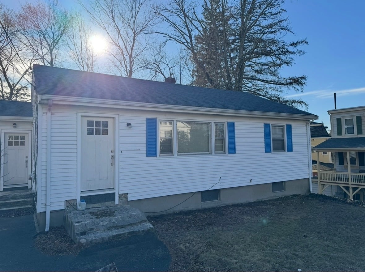 Single-story home with visible exterior wear, ideal for a fixer-upper purchase.