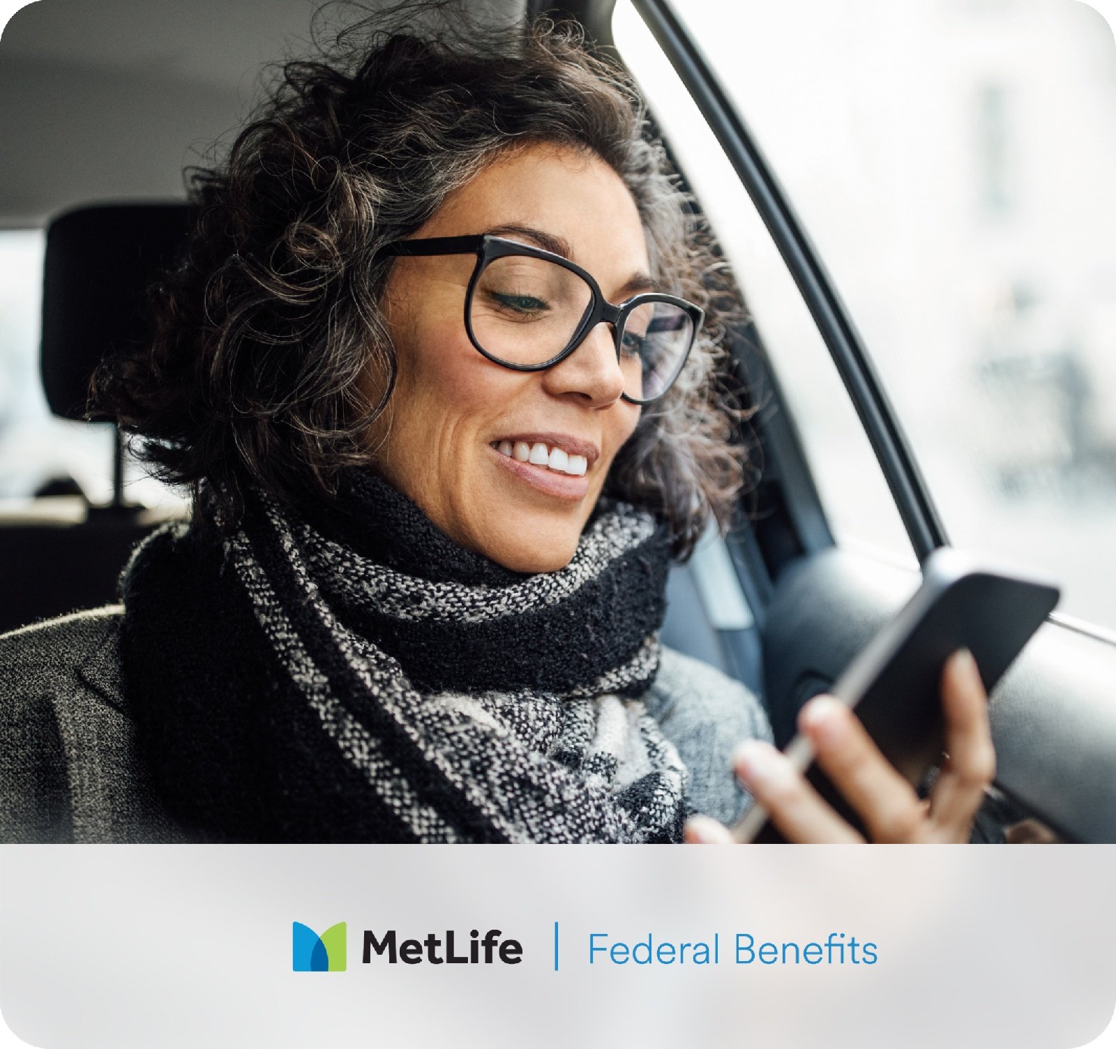 Woman in Car looking at phone