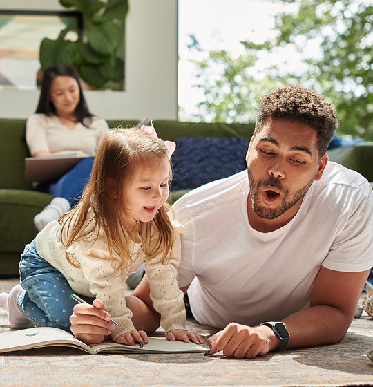 Mother and father playing with daughter