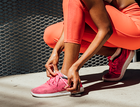 Woman tying her shoe