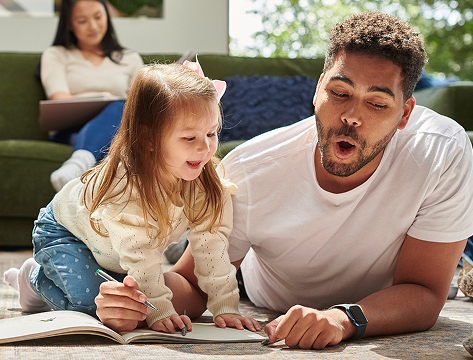 Mother and father playing with daughter